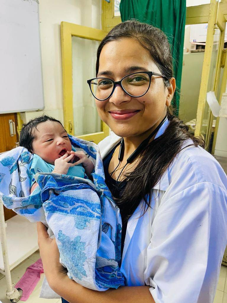 Dr. Preeti Garg with a newborn patient at WCare Ayurveda